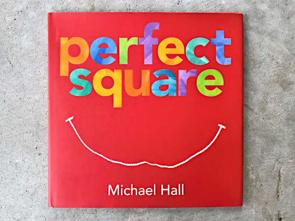 Cover of Perfect Square Picture Book by Michael Hall - a red, square book with the lettering for "perfect square" done in marbled rainbow