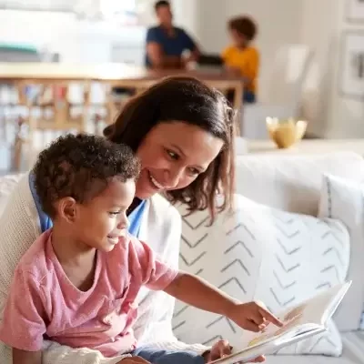 Mom and child slowing down during their day to read a children's book together, reconnect, and maybe even learn about God