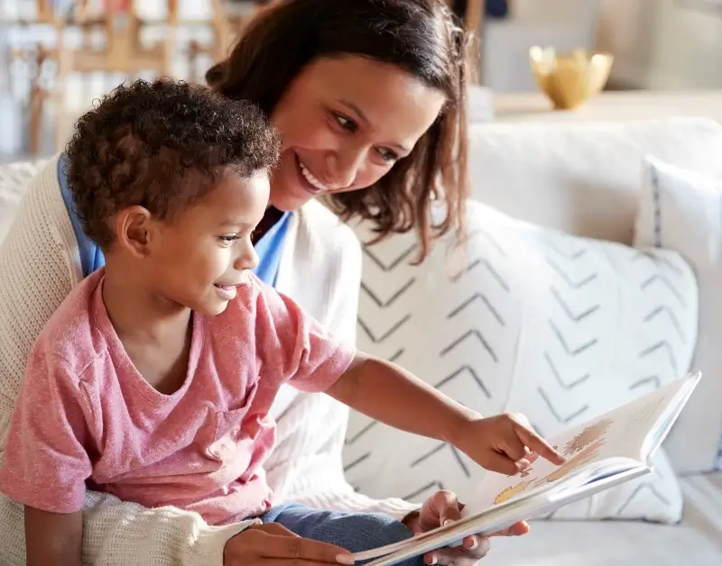Mom and child slowing down during their day to read a children's book together, reconnect, and maybe even learn about God